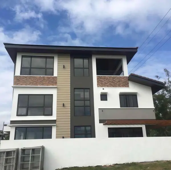UPVC Fixed Window | Modern House Installation | LuckyHome Philippines Modern three-story house featuring black-framed UPVC fixed windows – durable, sleek, and energy-efficient by LuckyHome Philippines