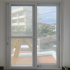 White UPVC Sliding Door | Balcony View | LuckyHome Philippines White UPVC sliding door with clear glass opening to balcony view – elegant, durable, and weatherproof design by LuckyHome Philippines