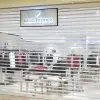 Motorized Transparent Polycarbonate Roll-Up Door for Retail Stores | LuckyHome PH Motorized transparent polycarbonate roll-up door installed at a retail clothing store, providing clear visibility, elegant aesthetics, and high-level security by LuckyHome Philippines.