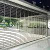 Stainless grill type roll up door installed at a modern commercial building entrance, providing transparent security and premium appearance by LuckyHome Philippines.
